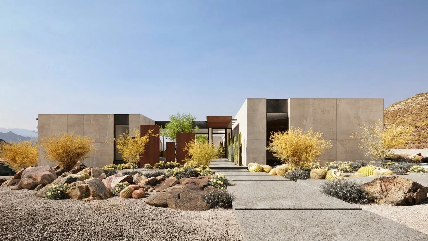 A concrete residence approached on a gravel walk through brittlebush and barrel cactus.